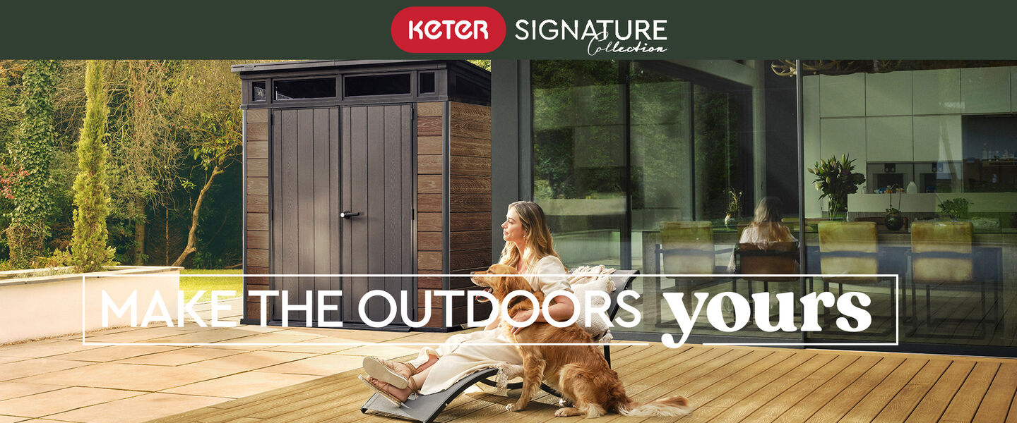 lady sitting on a sun lounger with her dog outside on her patio. Behind her is a Keter signature Walnut brown 7x7 pent shed 