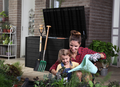 Save 20% on Storage Boxes & Benches. Mom and child gardening in front of Ontario storage box