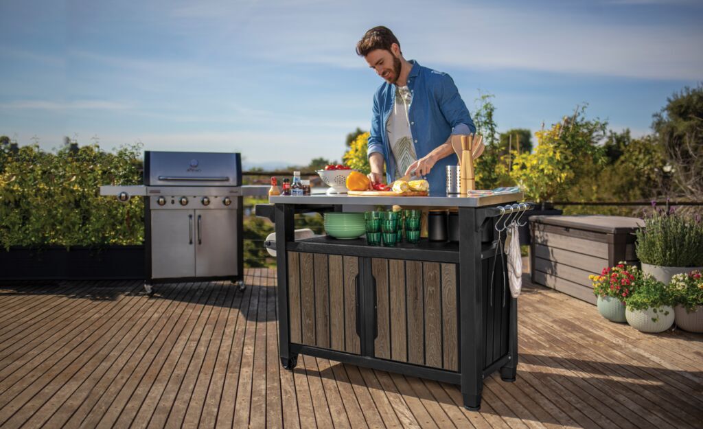 keter Signature Unity XL Outdoor Kitchen Cart Walnut Brown on patio with BBQ