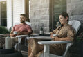 man and woman sitting in Adirondack chairs enjoying coffee