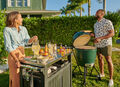 Husband and wife grill out for memorial day weekend