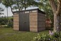 Keter Signature shed with windows surrounded by trees