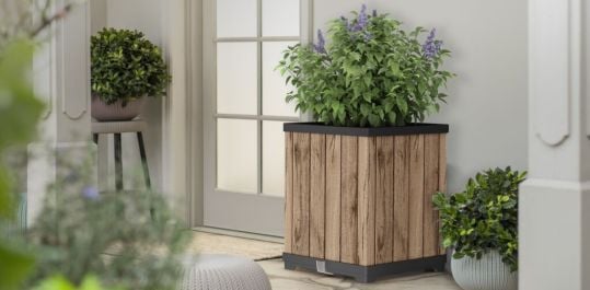 a wood-like planter box with flowers