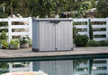Keter Store-It-Out Prime Shed sits next to a pool for storage