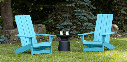 Set of blue adirondack chairs around an outdoor side table