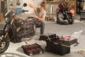 man fixing a bike with his toolbox chest close by