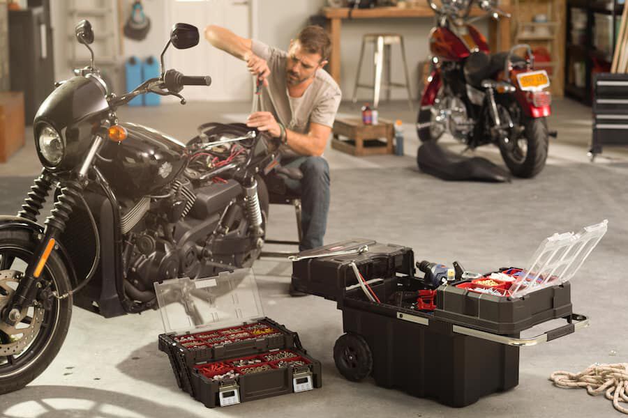 man in garage with keter rolling tool box