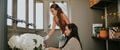 Two women potting plants inside keter potting shed