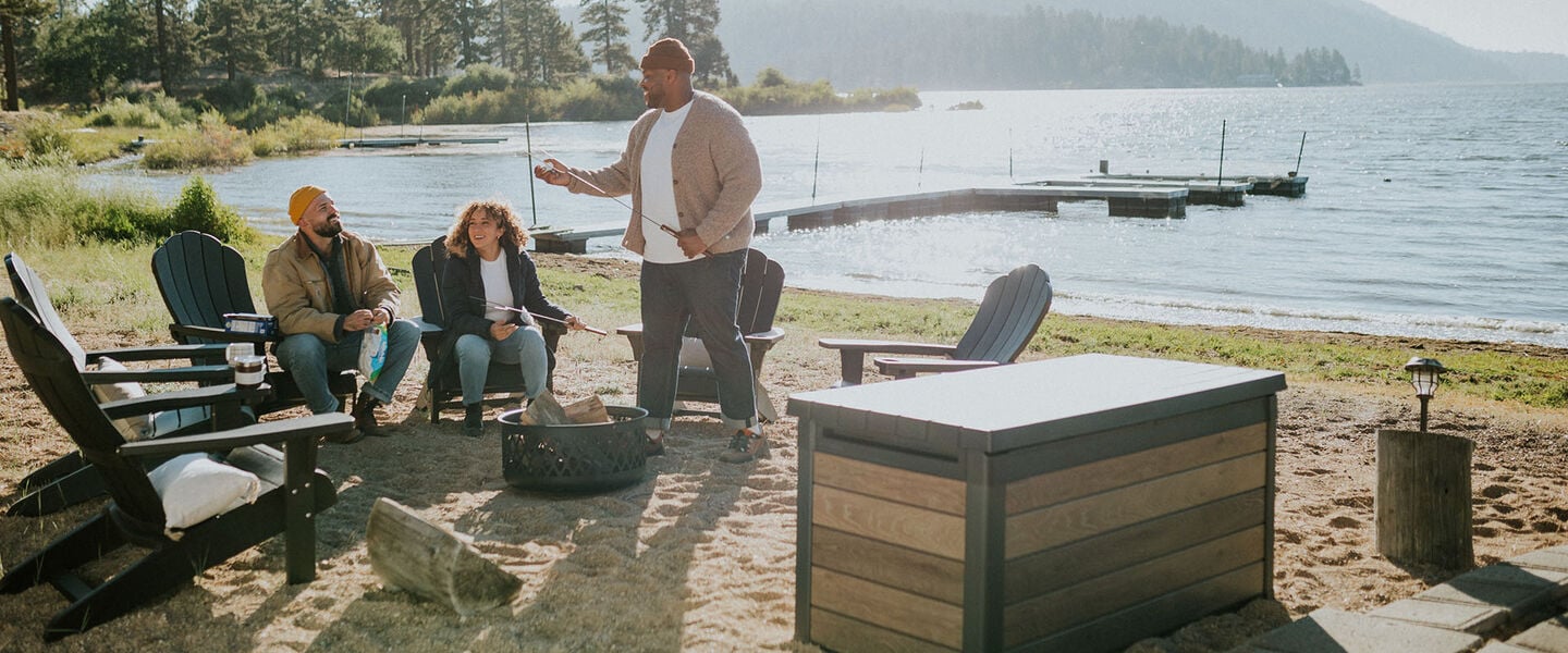 group of friend outside with a deck box close by