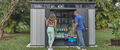 Fitness couple looking for exercise equipment in a storage shed
