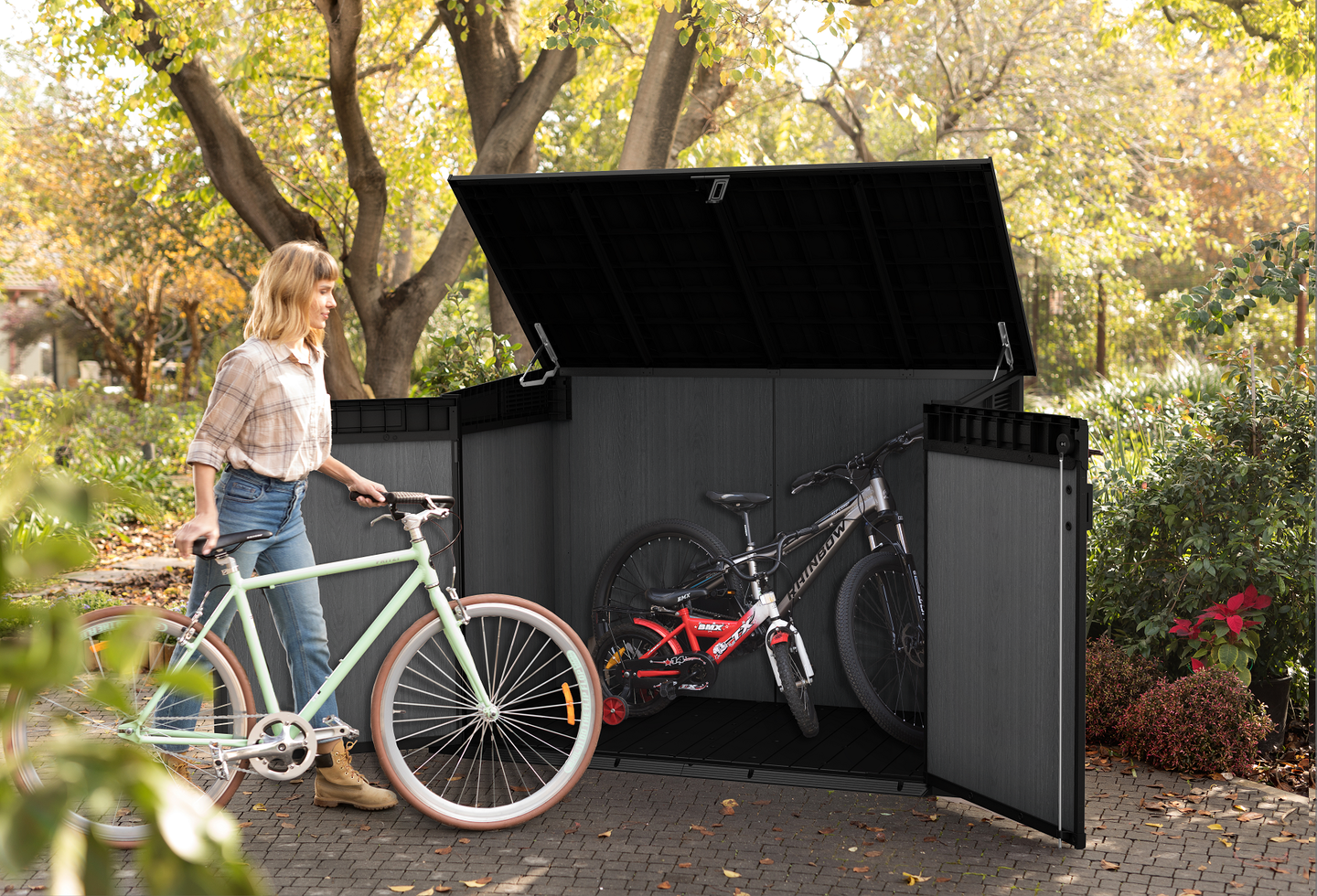 Woman putting her bike in a storage shed