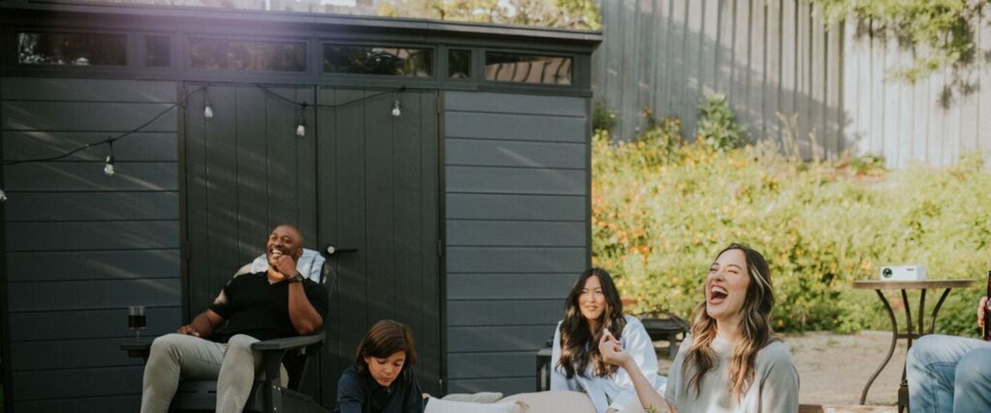 Family having a good time in front for storage shed