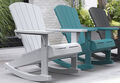 three Adirondacks in complementary colors sit together on a patio