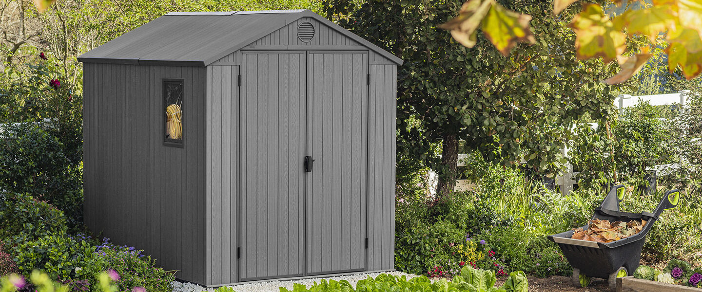 Gray storage shed in a backyard