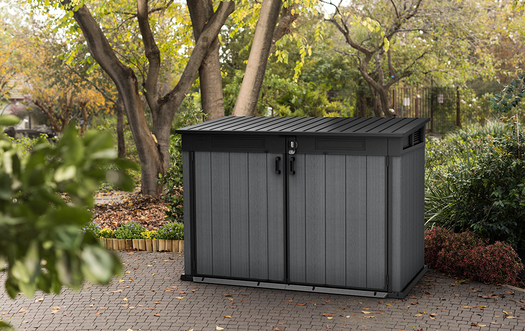small outdoor shed in front of a tree