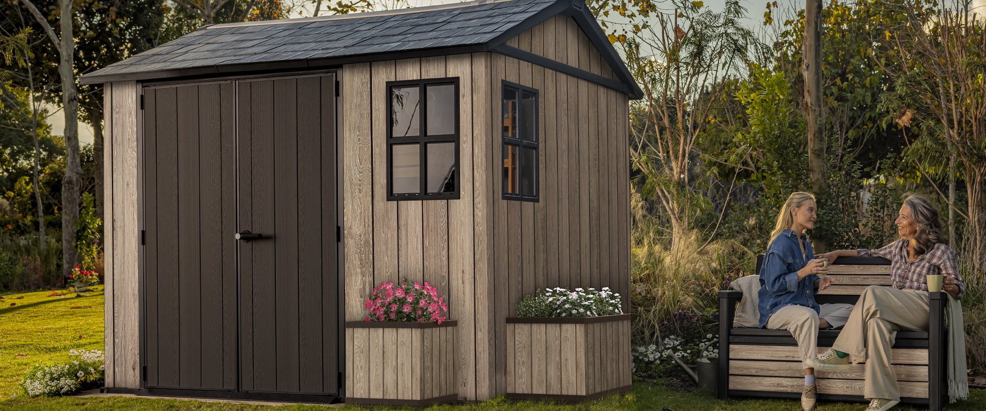 Friends Entertaining in a garden featuring a Keter shed