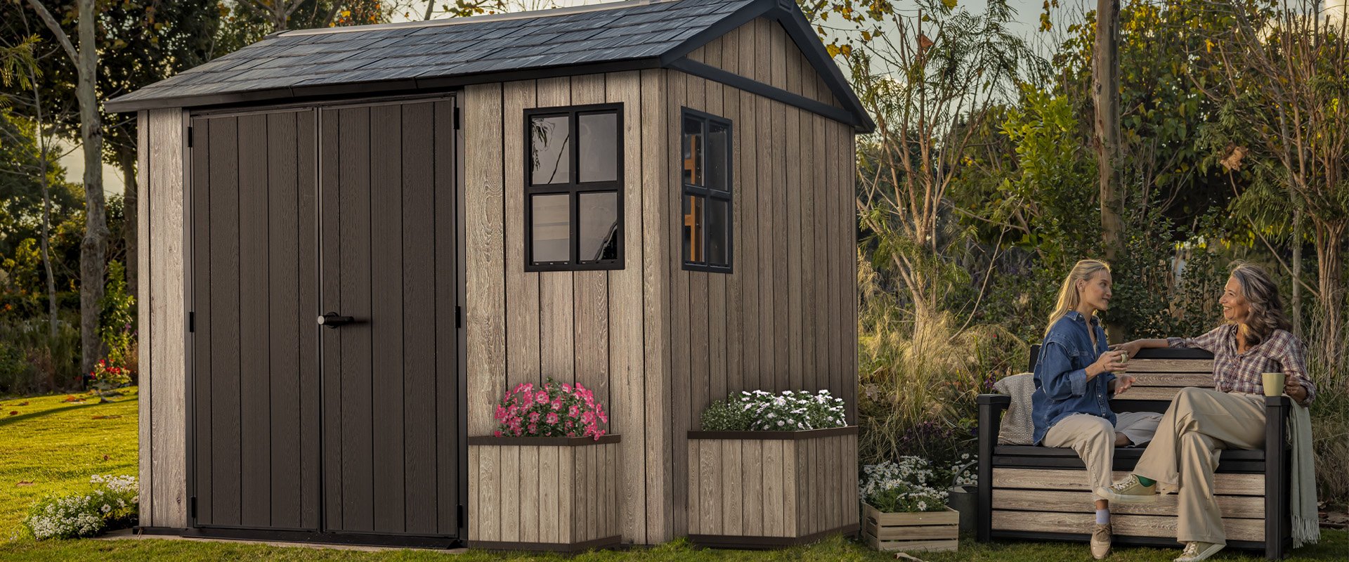 Friends Entertaining in a garden featuring a Keter shed