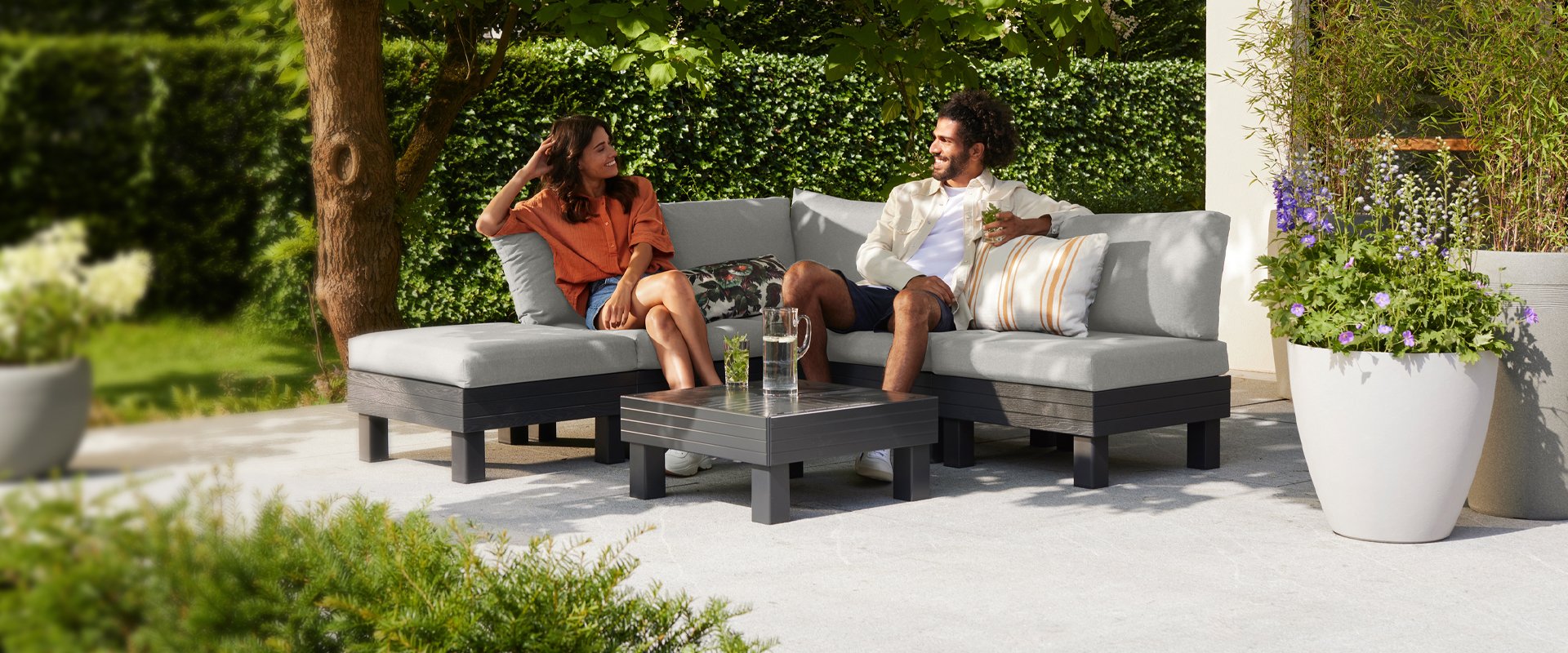 Couple relaxing on an Elements Garden Set on a patio