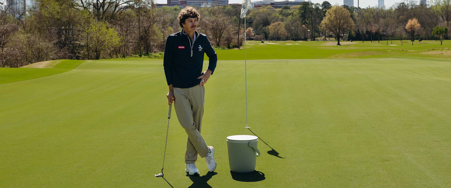 1 man standing on golf court next to Keter cool bar