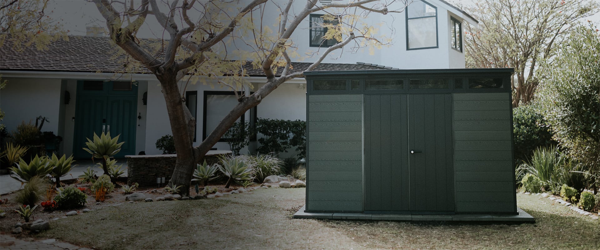 Keter green Cortina shed in backyard