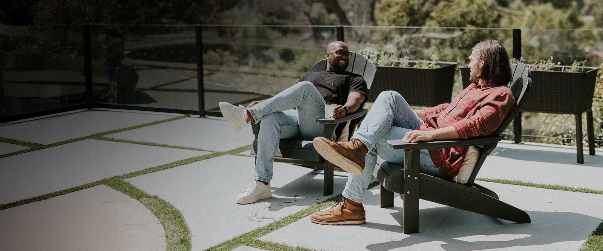 2 men sitting on deck in Keter gray Adirondack chairs